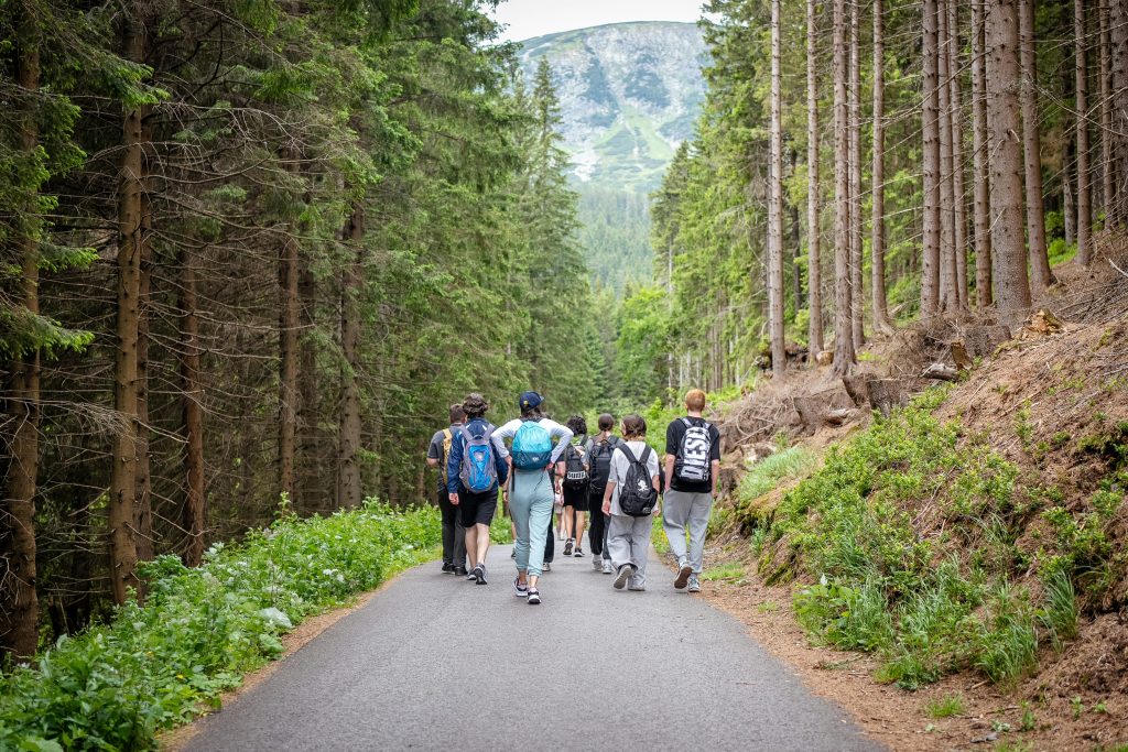Teen hiking in mountains to enjoy health benefits of travel