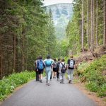 Teen hiking in mountains to enjoy health benefits of travel