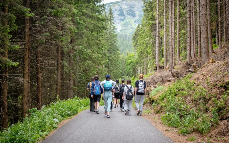 Teen hiking in mountains to enjoy health benefits of travel